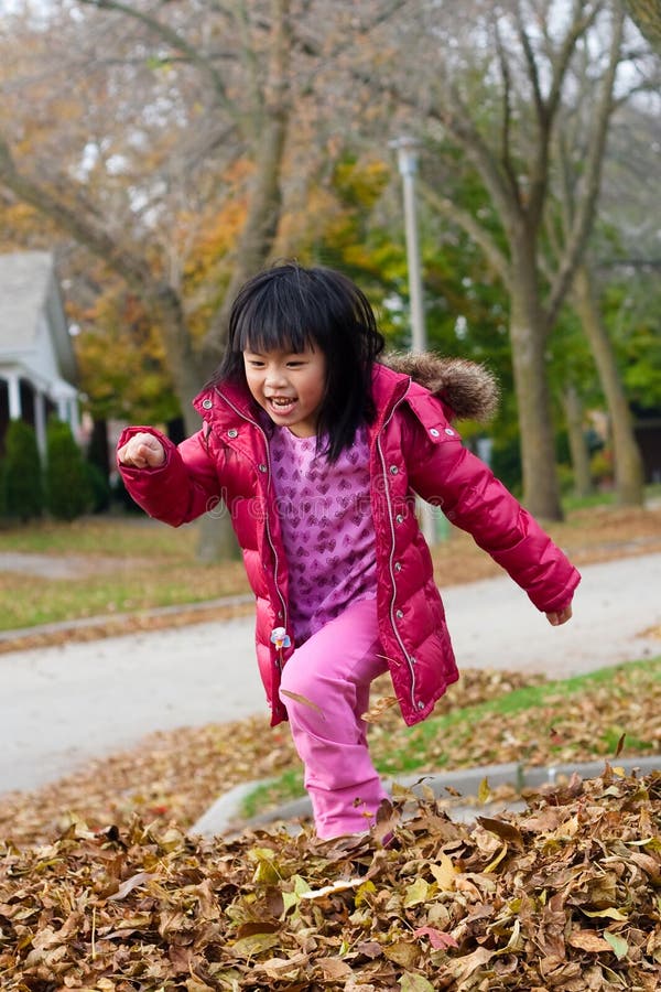 Download Girl Playing In Fall Leaves Stock Photo - Image of asian, jumping: 11514970