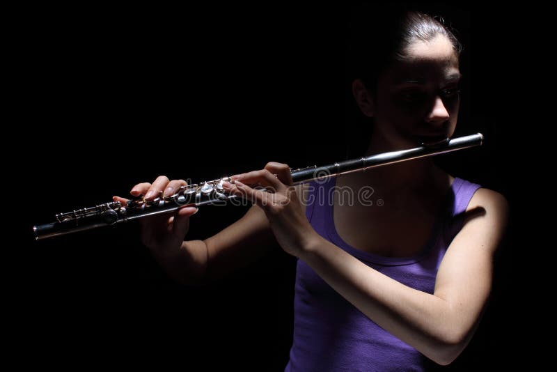 Girl playing a flute royalty free stock images