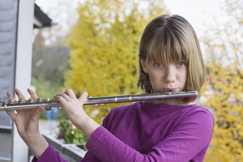 Girl playing flute stock photos