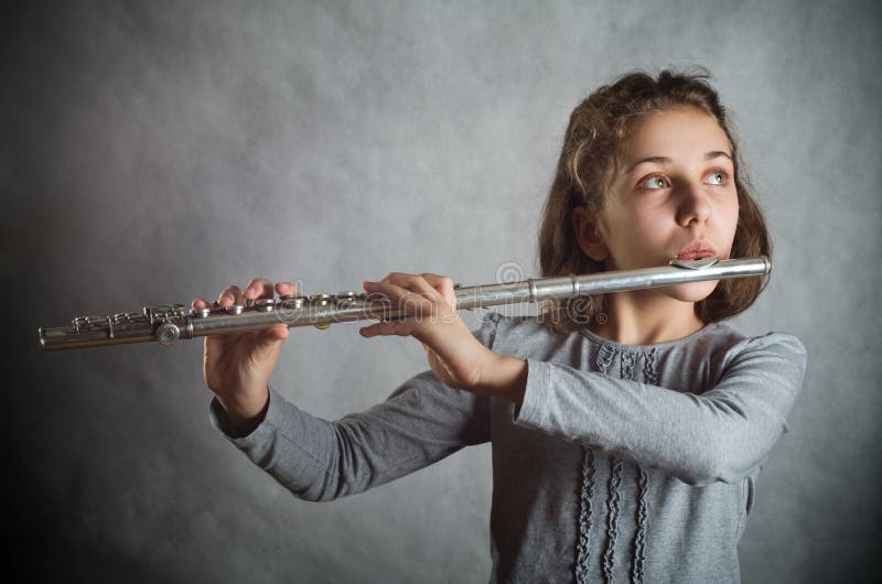 Girl Playing Flute royalty free stock photo