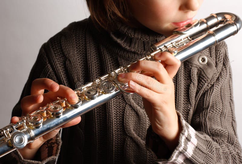 Girl playing flute stock image