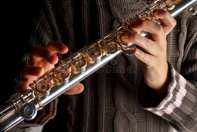 Girl playing flute stock photo
