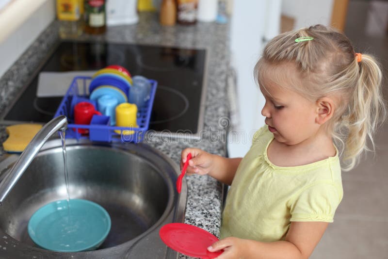 Girl playing in the kitchen royalty free stock photos