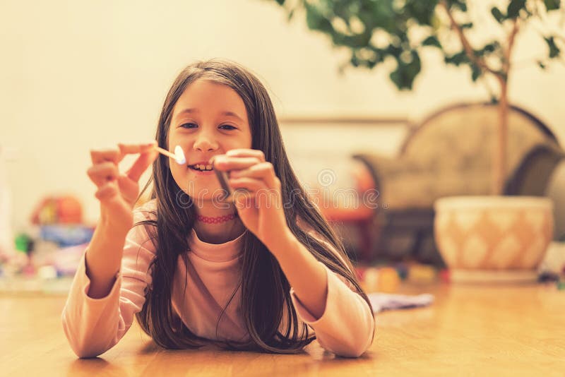 Girl playing with matches. Dangerous situation at home. A small child plays with matches, a fire, a fire flares up, danger, child