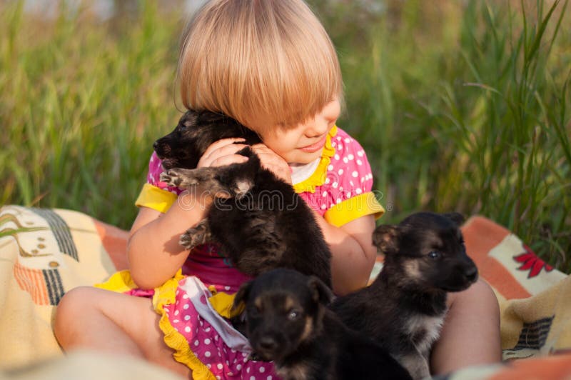 Girl playing with puppies