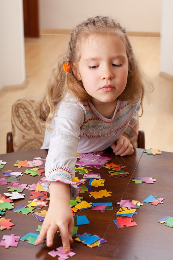 Child solving puzzle stock photo. Image of home, assignment 3361080