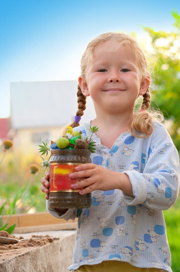 Girl playing with sand and plants