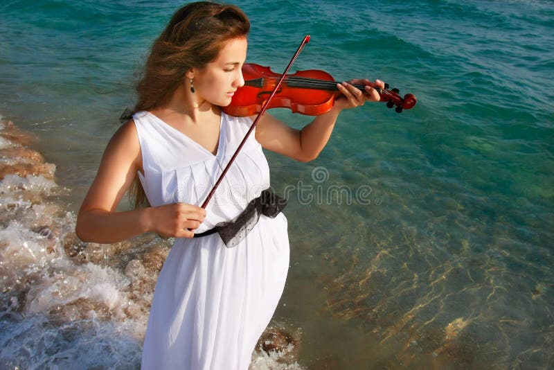 Girl playing violin on sea background