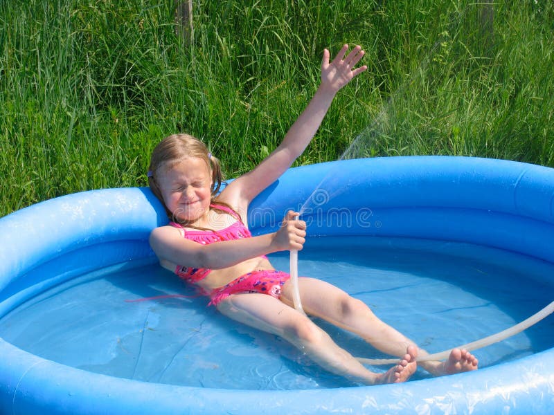 Girl playing in the watter stock images