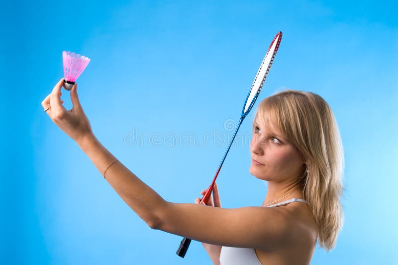 The girl plays badminton