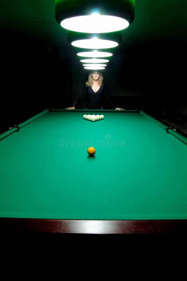 The girl plays billiards