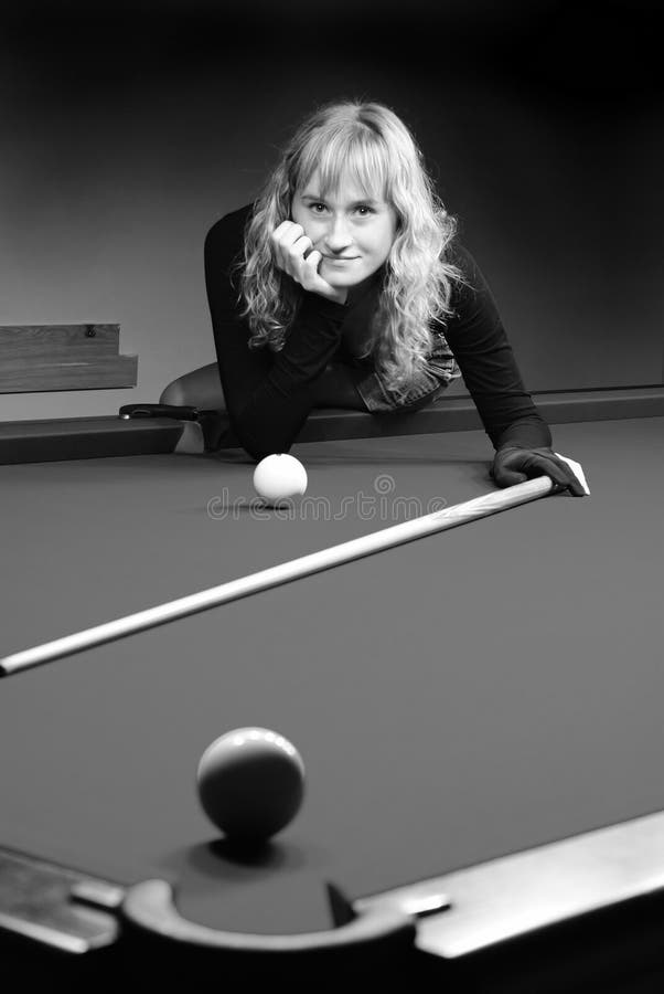 The girl plays billiards