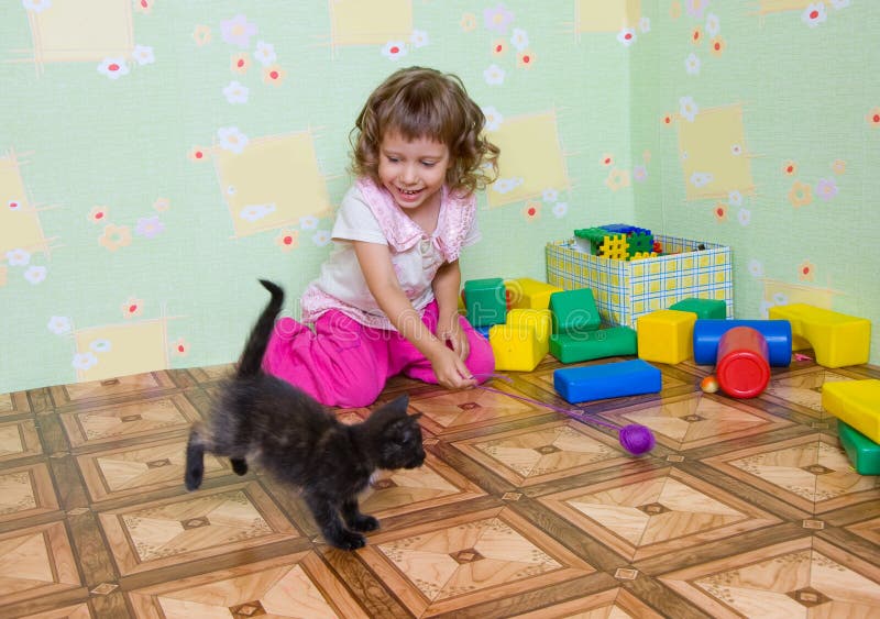 The girl plays with a kitten royalty free stock image