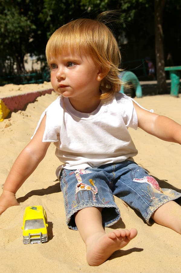 Girl plays sand on a beach