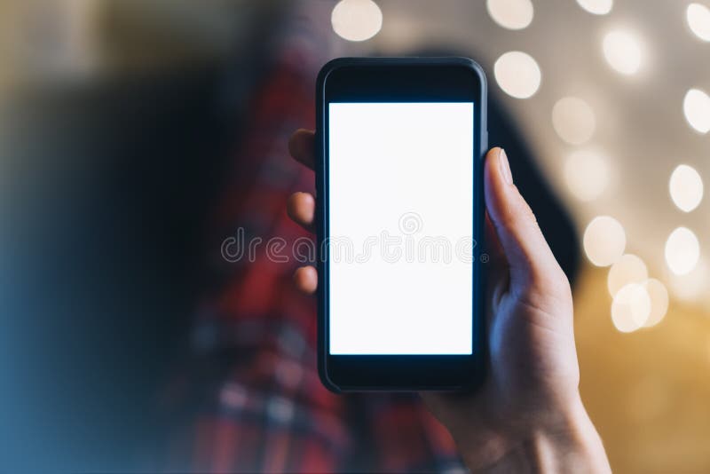 Girl pointing finger on smartphone with empty blank screen monitor on the background bokeh light in home atmosphere, freelancer royalty free stock images Girl pointing finger on smartphone with empty blank screen monitor on the background bokeh light in home atmosphere, freelancer royalty free stock images