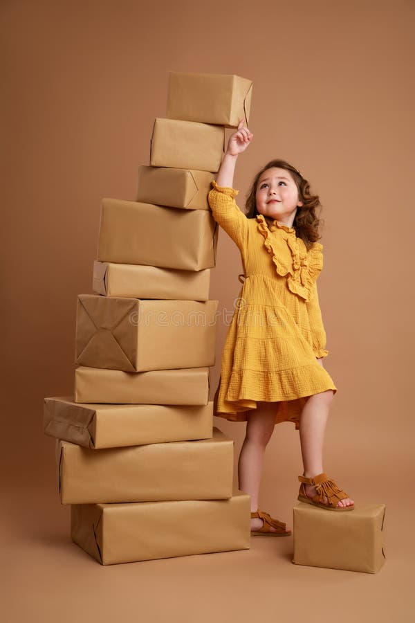 Girl pointing at a tall pile of gifts