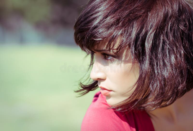 Girl is portrait into the profile on nature.