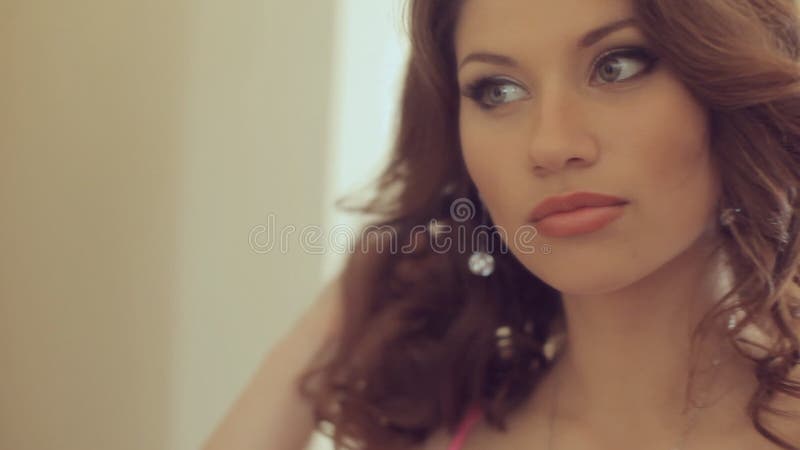 Girl posing in the bedroom. Face close up