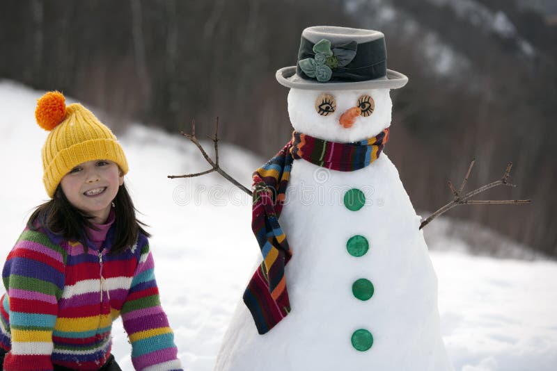 Girl posing with her snowman