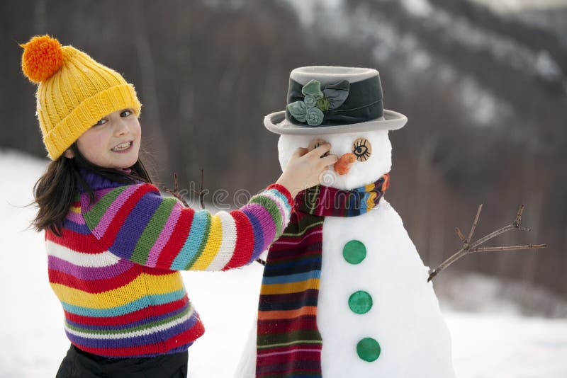 Girl posing with her snowman