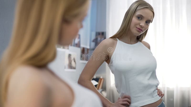 Teenager girl looking at mirror and checking her breast Stock Photo - Alamy