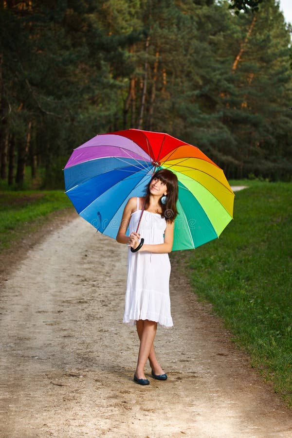 Girl posing with umbrella stock image. Image of rainbow 25189949