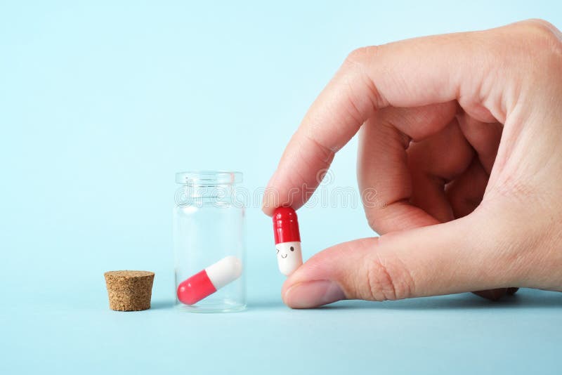 Girl pours the last pills into her palm on a light background close-up. vitamins. pharmaceuticals. chemical industry. remedies for viruses and bacteria. red and white pills