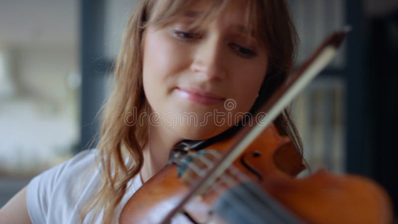 Girl practicing music on violin . Violinist performing composition on instrument