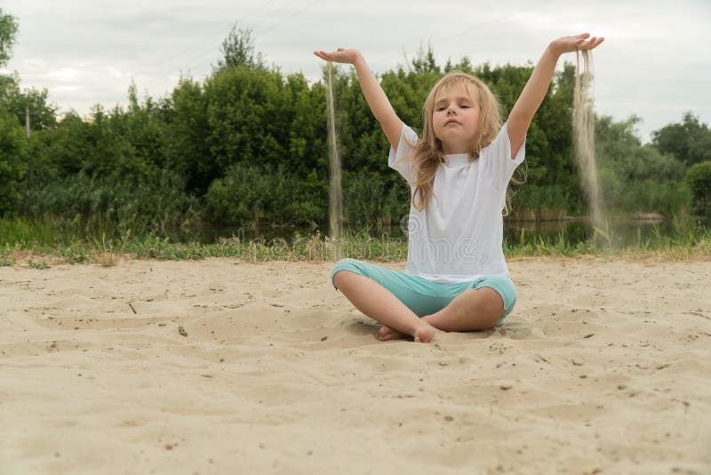 Girl practicing yoga on the beach. Toned image royalty free stock image Girl practicing yoga on the beach. Toned image royalty free stock image