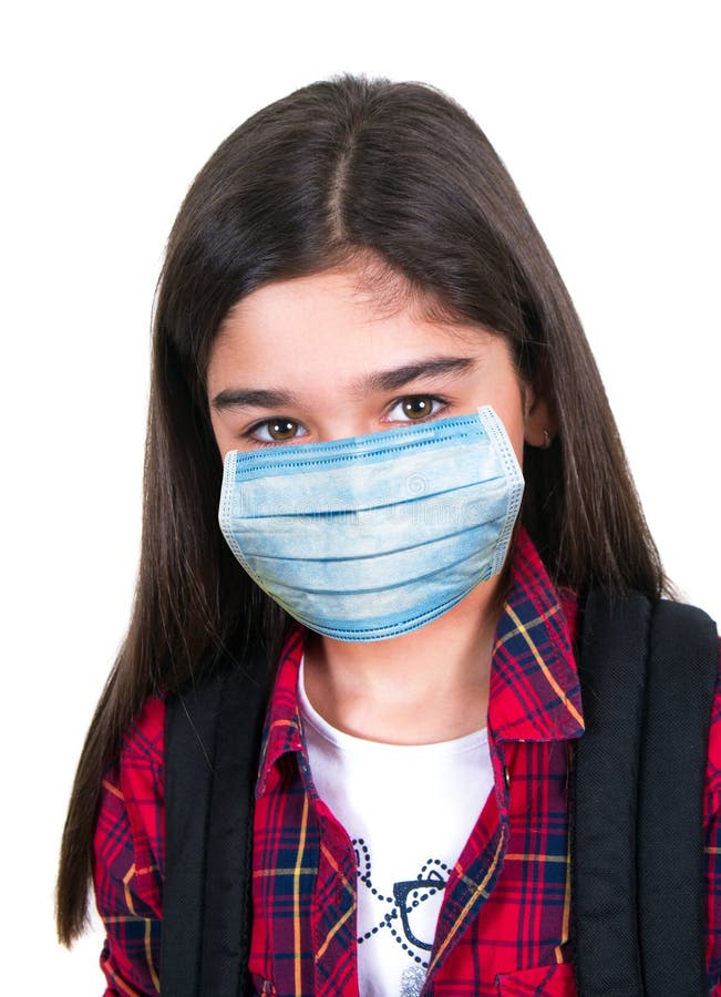 A Girl in Protective Medical Mask in Spring among the Blooming Garden