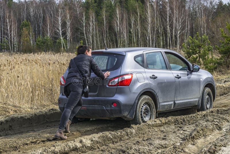 Sexy girl pushing car