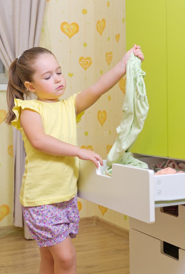 Girl Put A Clothes To Case Box In A Home Stock Image Image of child