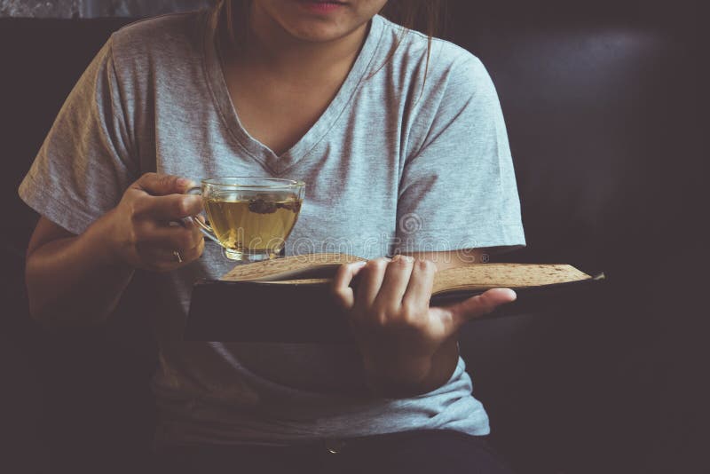 A Girl Reading Book with a Cup of Green Tea Stock Image Image of
