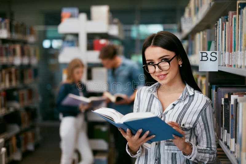 Girl Reading Book In Library. Student Learning stock image