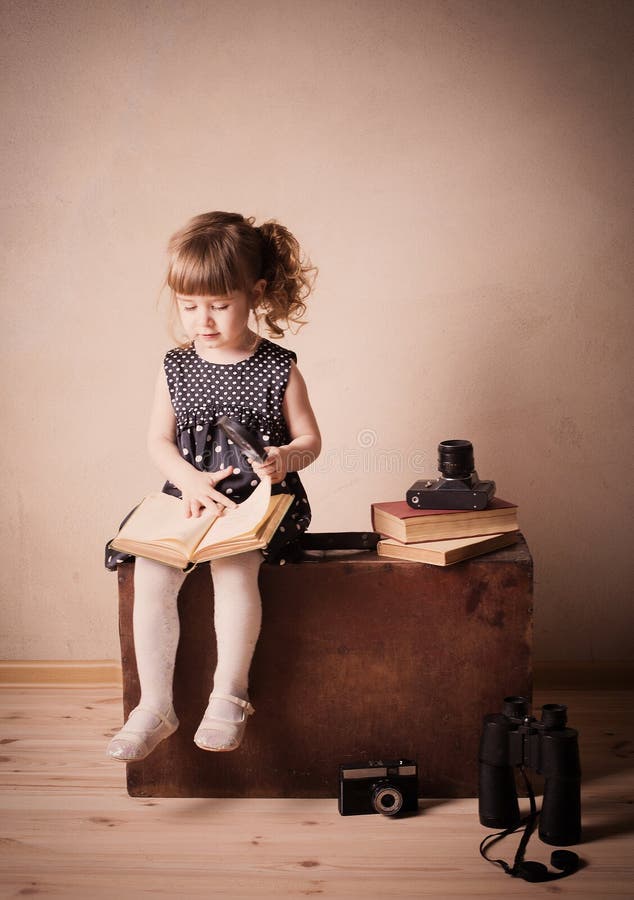 Girl Reading a Book on the Old Suitcase Stock Photo Image of