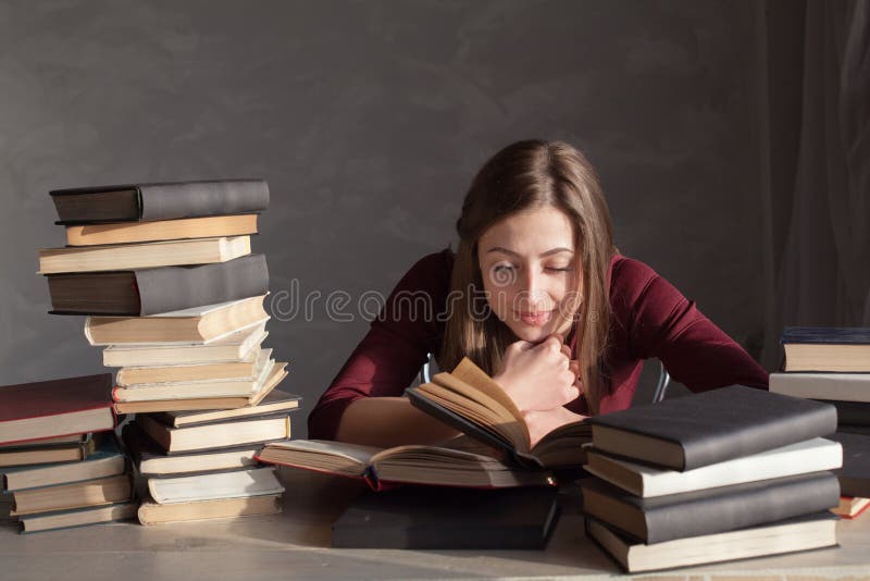 Girl Reading Book Prepares for the Exam in the Library Stock Photo