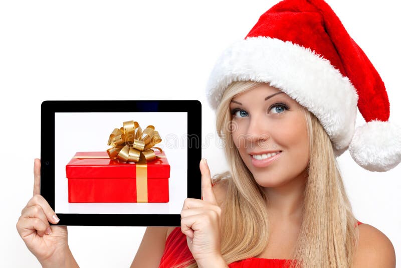 Girl in a red Christmas hat holding tablet