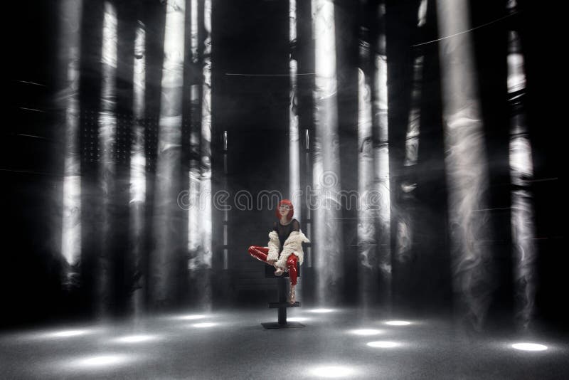 The girl with red hair in the spotlights at night club royalty free stock photography The girl with red hair in the spotlights at night club royalty free stock photography