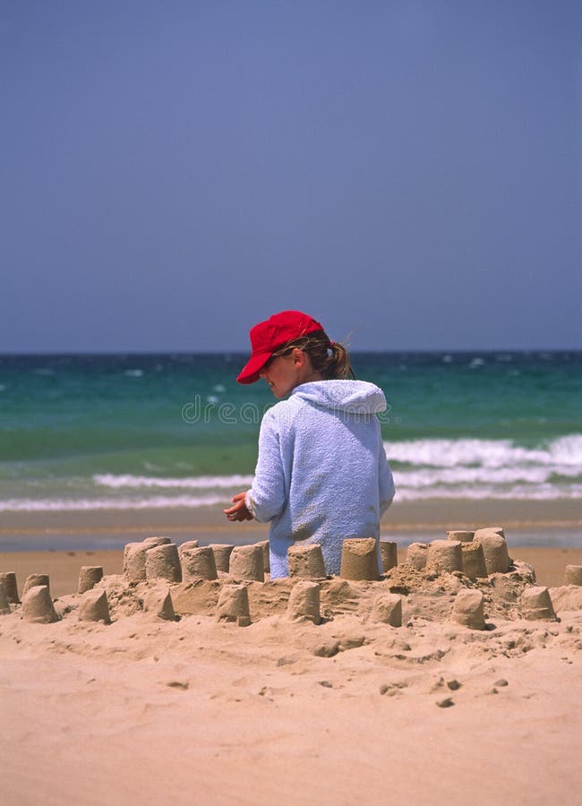 Girl in red hat on beach