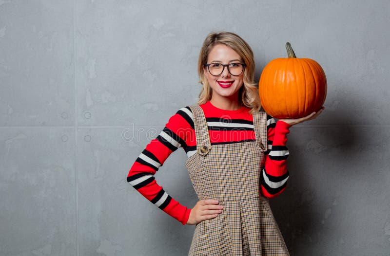 Girl in red striped sweater with halloween pumpkin royalty free stock photo Girl in red striped sweater with halloween pumpkin royalty free stock photo