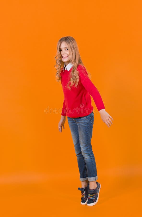 Girl in Red Sweater and Jeans Stand on Tiptoe Stock Photo - Image of ...
