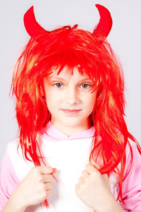 Girl In A Red Wig With Small Horns Stock Photo - Image of horns