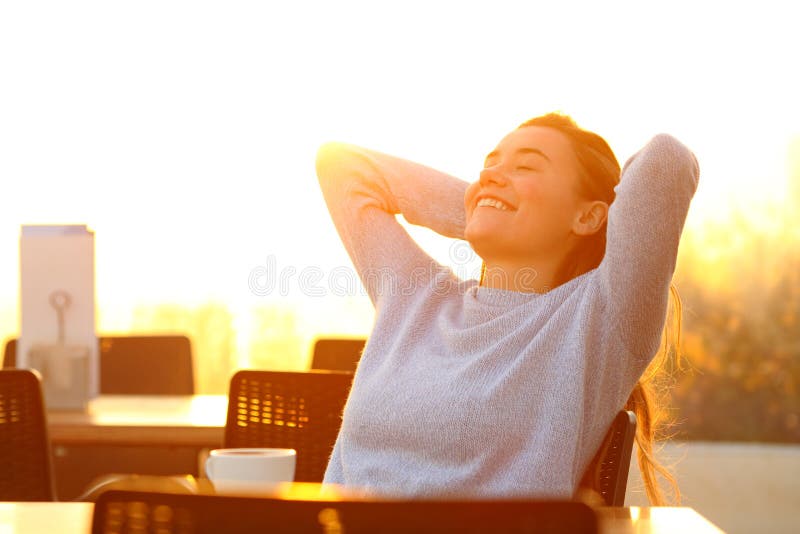 Girl relaxing at sunset in a coffee shop terrace stock photos Girl relaxing at sunset in a coffee shop terrace stock photos
