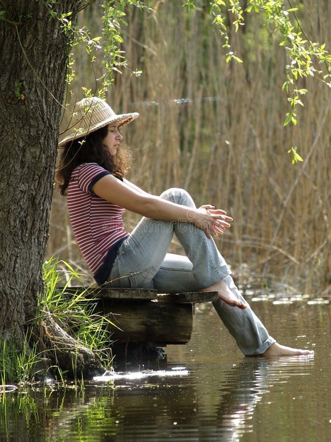 Girl resting near lake