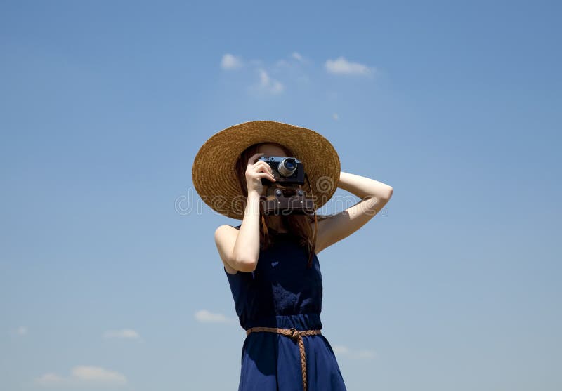 Girl with retro camera at blue sky