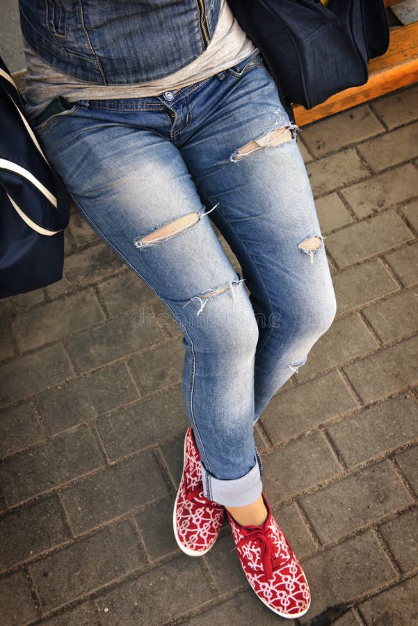 Girl in ripped jeans stock photo. Image of green, pockets 32311056