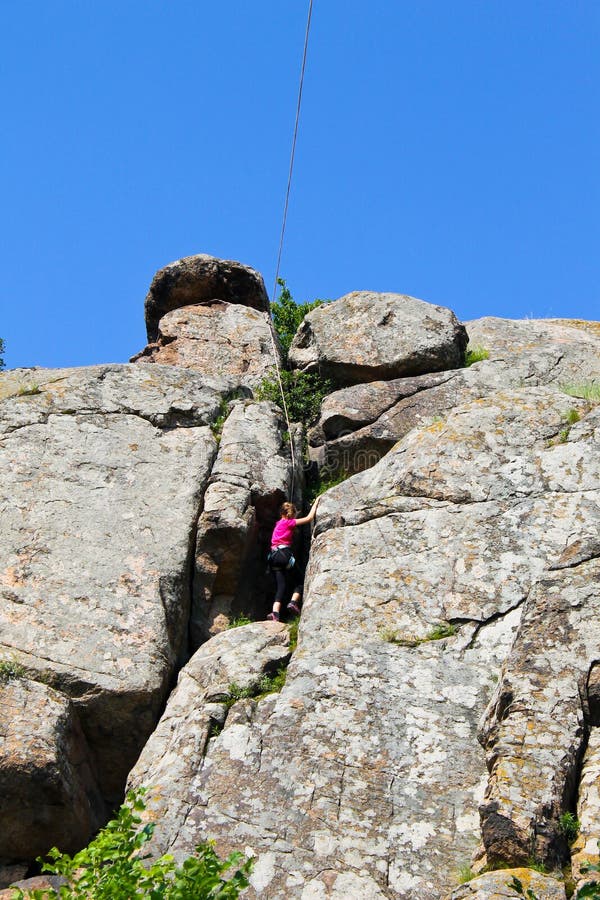 Girl rock climber climbs on a rock stock photography Girl rock climber climbs on a rock stock photography