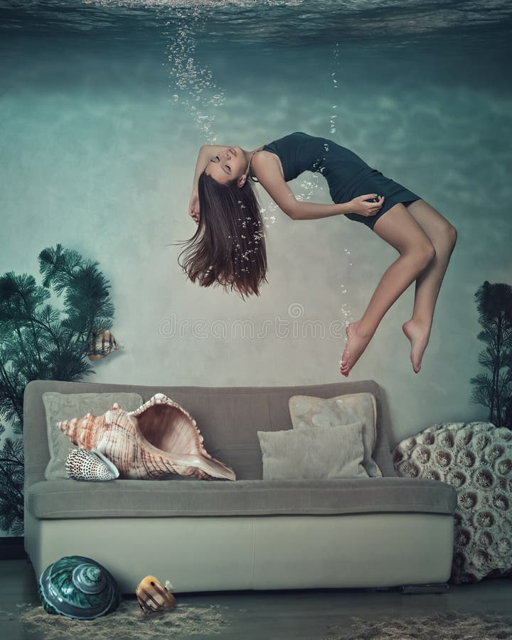 The girl in the room is swimming underwater.