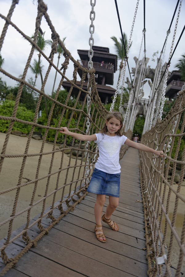 Girl on a rope wood bridge, Sentosa Island