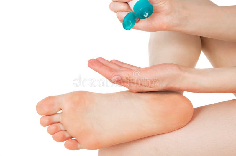 Girl rubs cream heel, feet